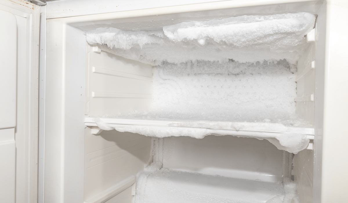 Heavy frost and ice buildup inside a freezer compartment