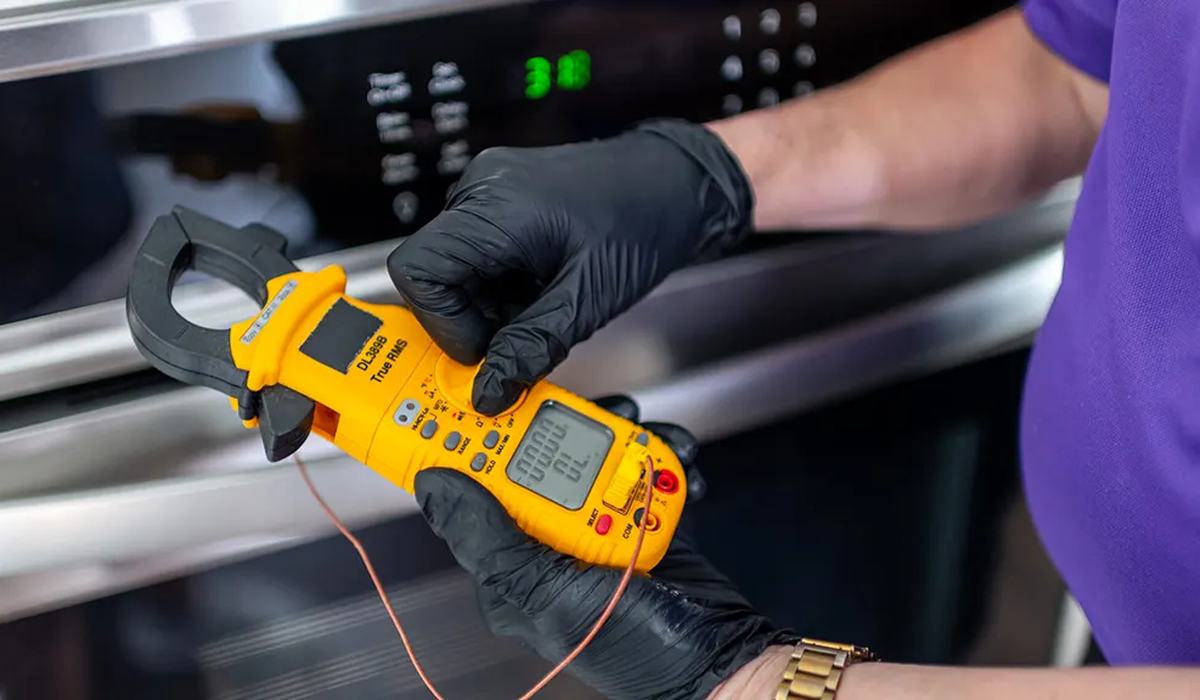 Multimeter testing refrigerator compressor terminals